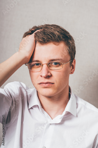 Fototapeta Naklejka Na Ścianę i Meble -  Depressed young business man holding his head