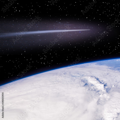 Comet flying above the earth. The elements of this image furnished by NASA.