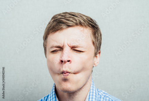 Принти на полотні man sucks his cheeks