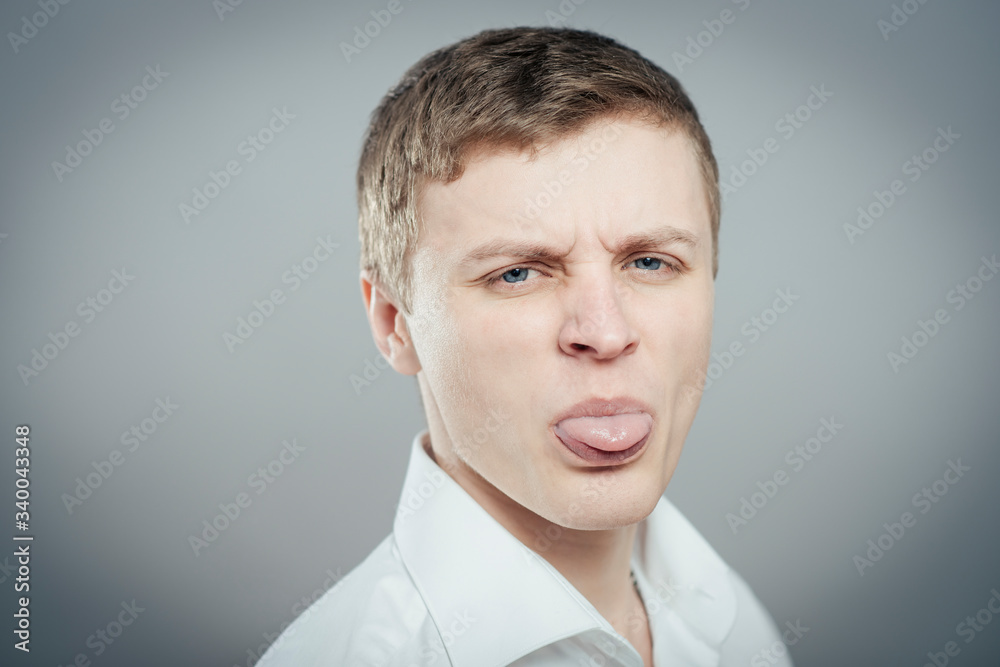 Adult man with bad manners - showing his tongue Adult man with bad manners - showing his tongue