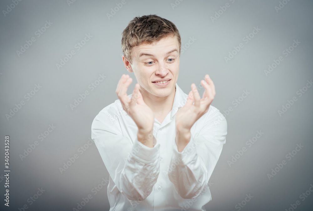 young man looking shocked and surprised in full disbelief hands up in air young man looking shocked and surprised in full disbelief hands up in air