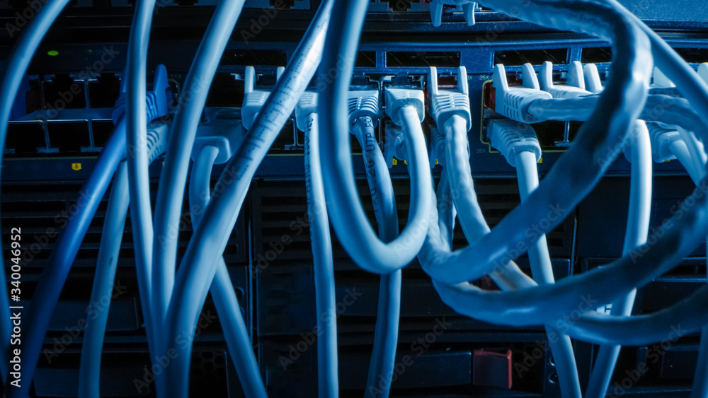 Close-up Macro Shot: Ethernet Cables Connected to Router Ports. Telecommunications: RJ45 Device Connectors Plugged into Modem Hubs. Close-up Macro Shot: Ethernet Cables Connected to Router Ports. Telecommunications: RJ45 Device Connectors Plugged into Modem Hubs.