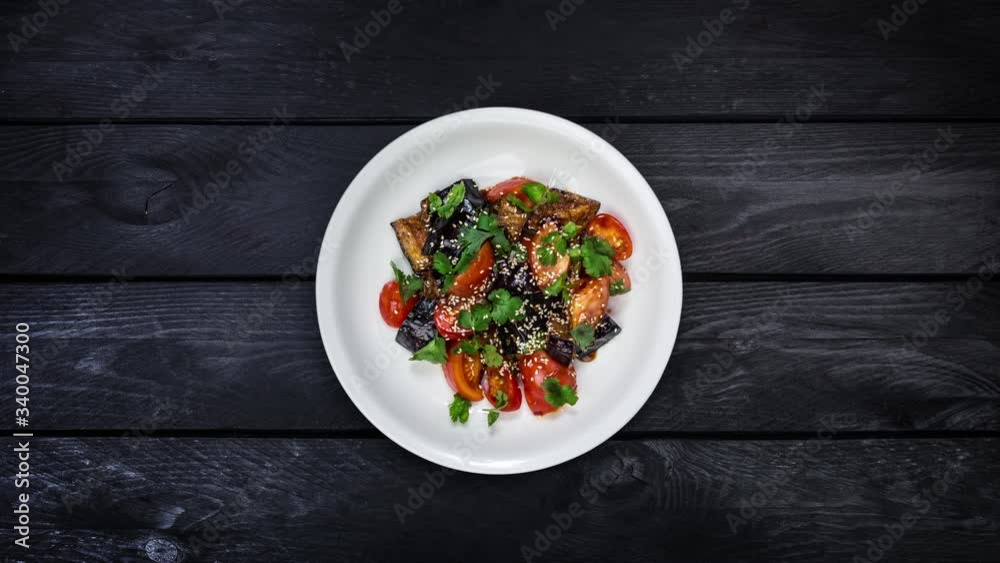Rotating salad of fried eggplant with tomatoes in Asian dressing. Rotating salad of fried eggplant with tomatoes in Asian dressing.