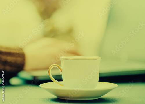 Man works in bussiness office with computer or laptop or notebook and papper graf and he drinks coffee