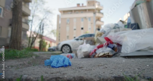 Surgical hand gloves thrown on ground by thrash in city street covid 19 pandemic crisis ecology
