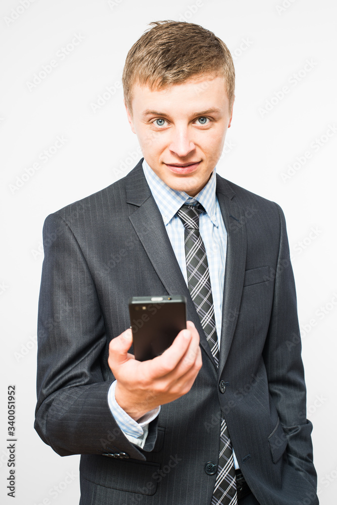 The man is using a smartphone. Modern mobile phone in hand. The man is using a smartphone. Modern mobile phone in hand.