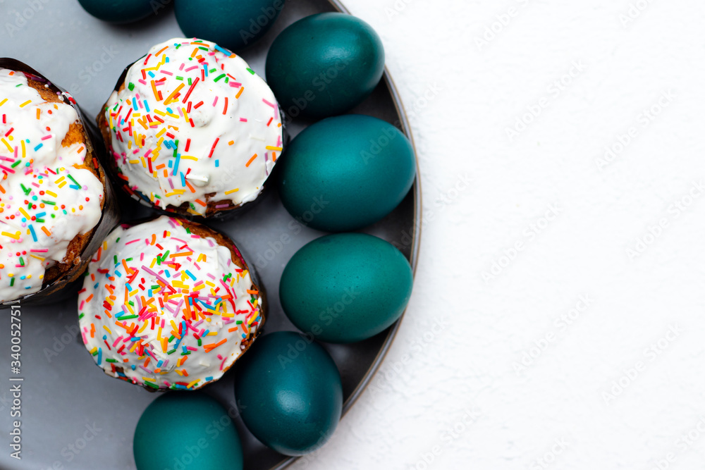 Easter cakes on a gray plate. Religious holiday. Place under the text. Easter banner. Frosting on the sandwich.