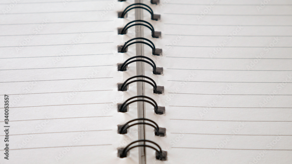 Close up top view of spiral notepad paper background. Close up top view of spiral notepad paper background.