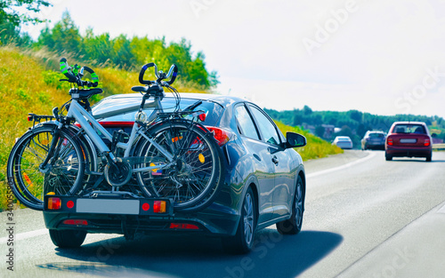 Car with bicycles in road in Poland concept reflex