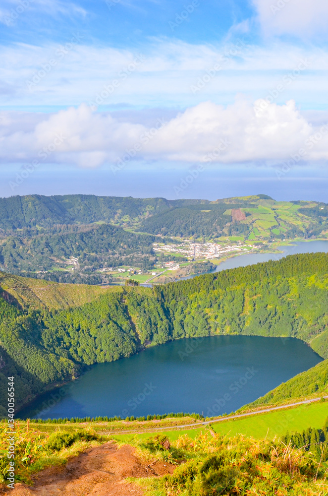 Viewpoint Miradouro da Boca do Inferno in Sao Miguel Island, Azores, Portugal. Amazing crater lakes surrounded by green fields and forests. Beautiful Portuguese landscape. Vertical photo
