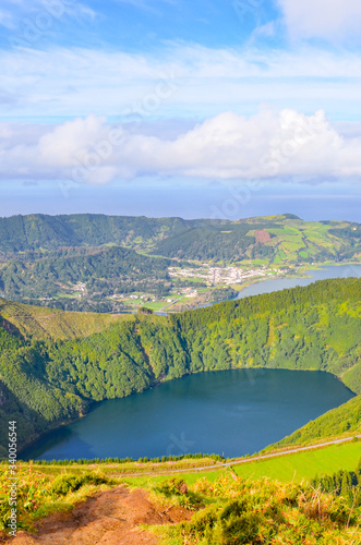 Viewpoint Miradouro da Boca do Inferno in Sao Miguel Island, Azores, Portugal. Amazing crater lakes surrounded by green fields and forests. Beautiful Portuguese landscape. Vertical photo