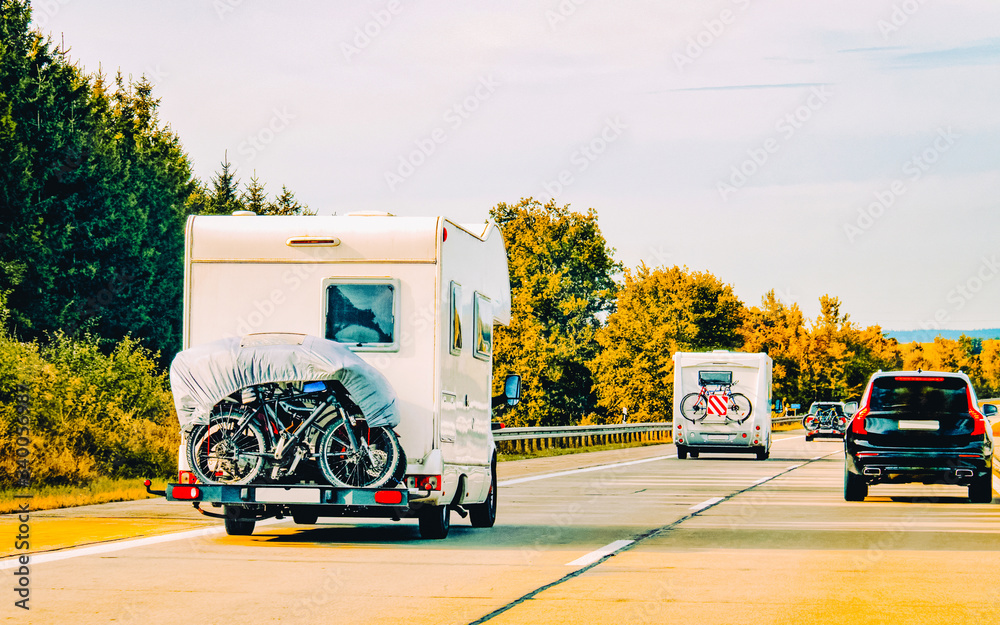 RV Camper Car and bicycles on Road in Switzerland reflex