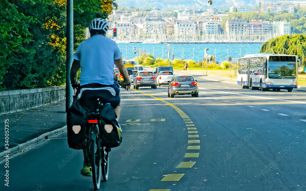 Man on bicycle on road in Geneva Switzerland reflex