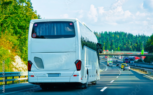 White Tourist bus in road in Poland reflex