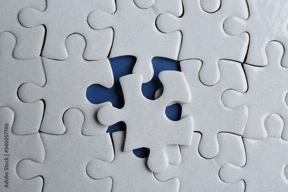 White puzzle on blue background, top view. Career promotion concept White puzzle on blue background, top view. Career promotion concept