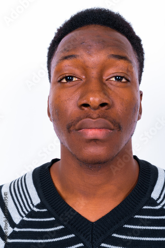 Young handsome African man against white background