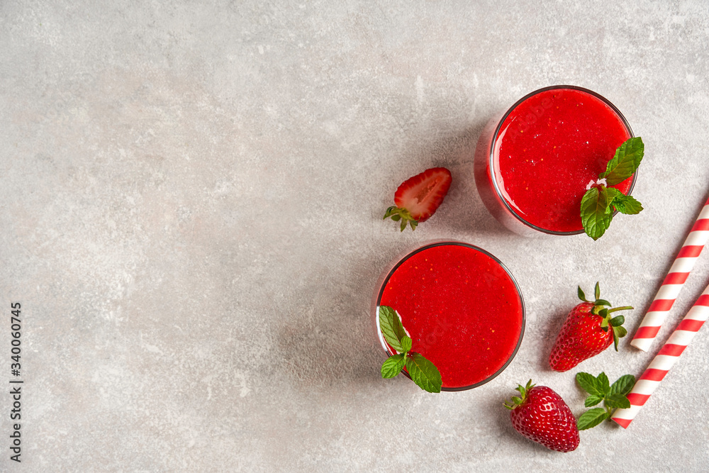  Strawberry smoothie on gray stone background. Top view with copy space