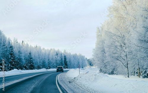 Landscape of car at road in snowy winter Lapland reflex