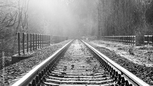 Dream journey. Railroad tracks at sunset time. Summer haze