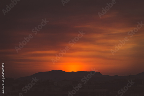 Sun goes behind the mountain in a sunset