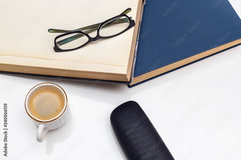 reading glasses on books and given its case along with a cup of coffee reading glasses on books and given its case along with a cup of coffee