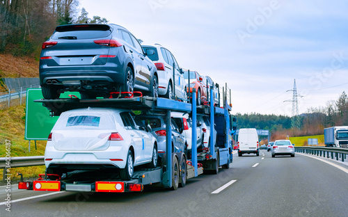 Car carrier transporter truck on road reflex