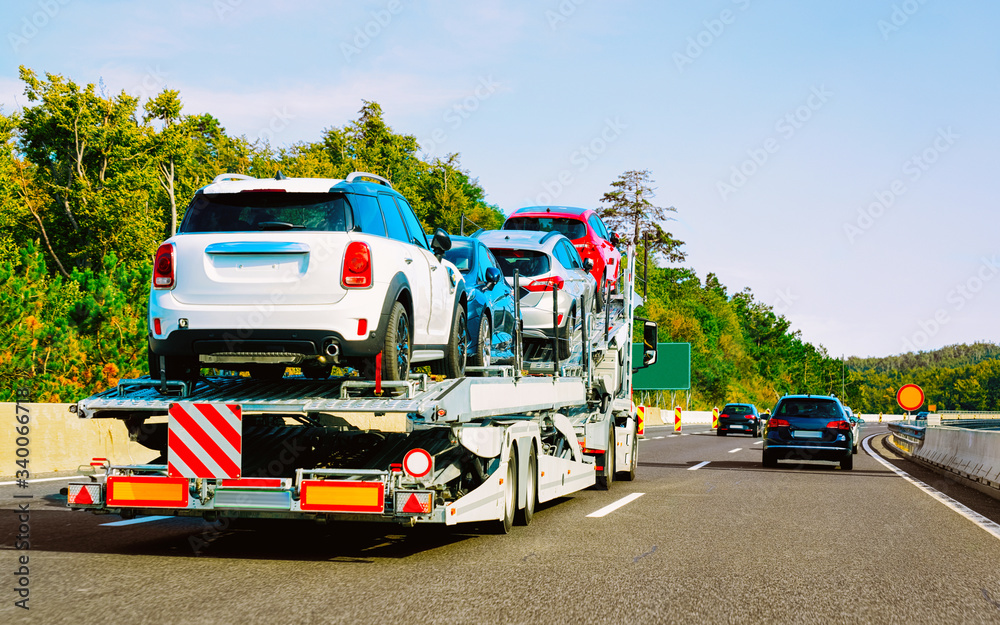 Cars carrier truck in asphalt road in Slovenia reflex