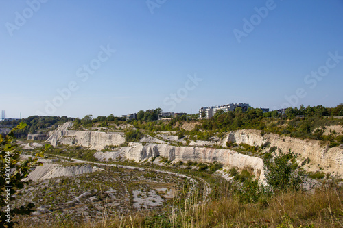 Some buildings stand at the edge of the limestone quarry called Kalkbrottet in Malmö, Sweden. The area is no longer in use, and now a nature reserve
