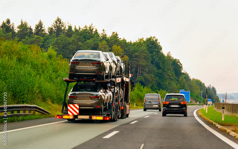 Cars carrier truck in asphalt highway road in Poland reflex