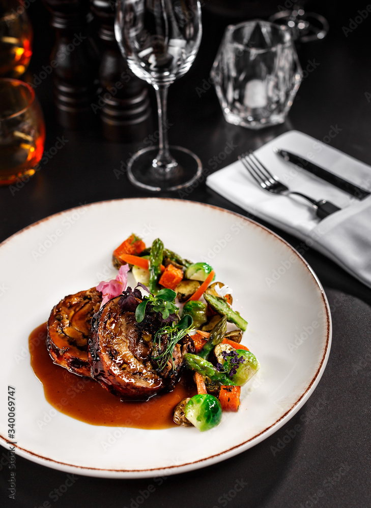 Healthy main course dish fro vegetarian. Eggplant with sauce and mixed tasty vegetables on the side. Food photography in fine dine in table background concept for cook book or magazine. Healthy main course dish fro vegetarian. Eggplant with sauce and mixed tasty vegetables on the side. Food photography in fine dine in table background concept for cook book or magazine.