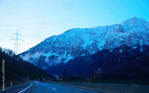 Road with view on Alpine mountains in Austria evening reflex
