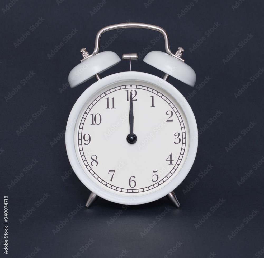 Old-style alarm clock, black and white, it's twelve o'clock. Old-style alarm clock, black and white, it's twelve o'clock.