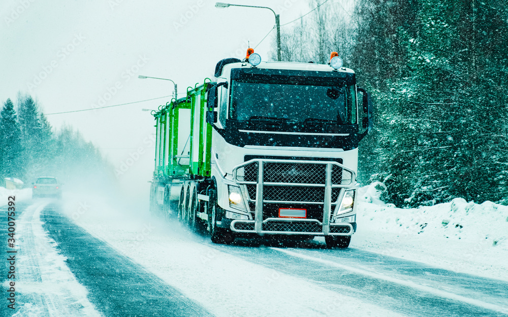 Truck in Snowy winter Road at Finland in Lapland reflex Truck in Snowy winter Road at Finland in Lapland reflex
