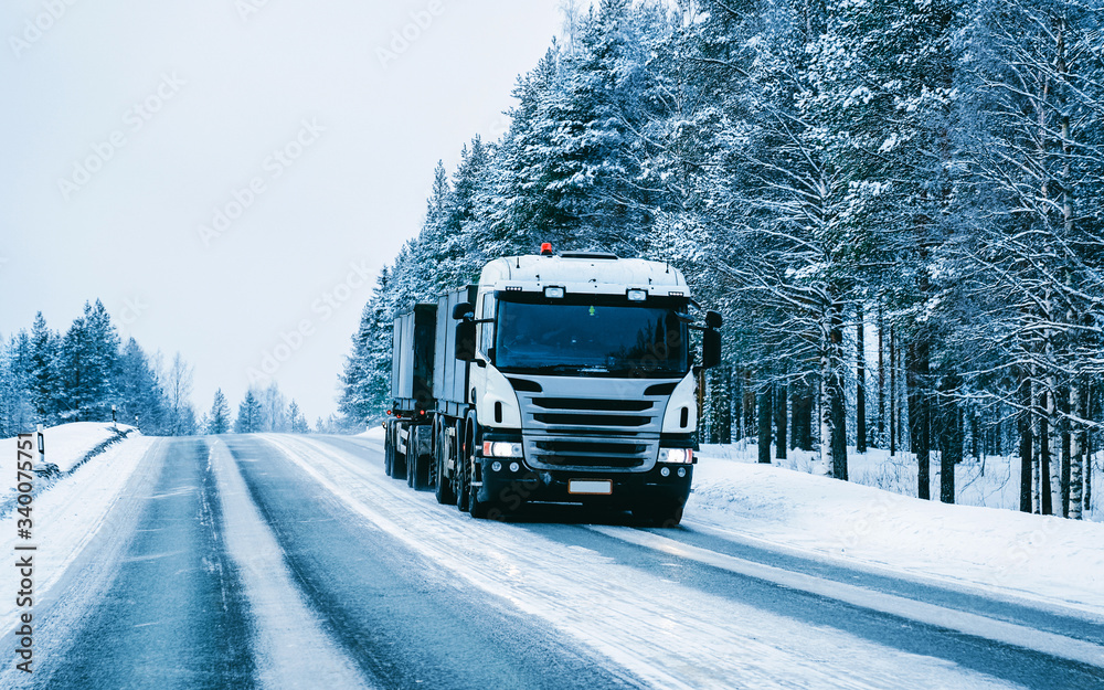 Obraz premium Truck on the Snowy winter Road in Finland of Lapland reflex