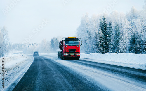 Truck on the Snowy winter Road in Finland Lapland reflex