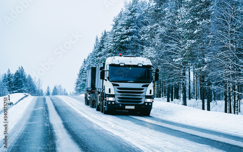 Truck on the Snowy winter Road in Finland of Lapland reflex