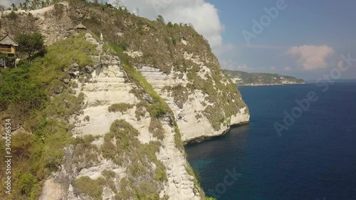 Aerial view at sea and rocks. Summer seascape from air with a drone.. Banah Cliff, Nusa Penida, Bali, Indonesia. Turquoise water background photo