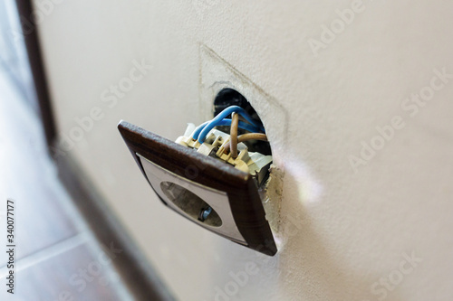 Φωτογραφία Brown broken electrical socket fell out of the wall