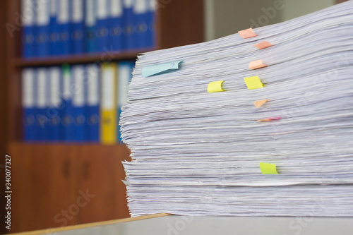 documents in large quantities are on the table. archived paper reports.