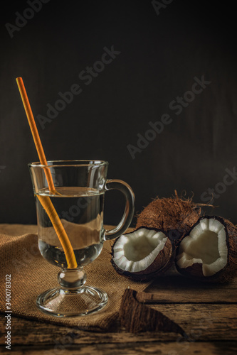 glass of fresh coconut milk with coconuts