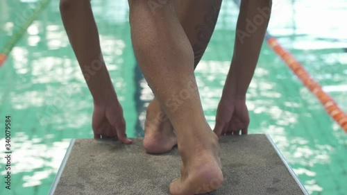professional swimmer jumping to swimming pool