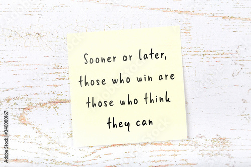 Wise quote on sticky note on wooden wall 