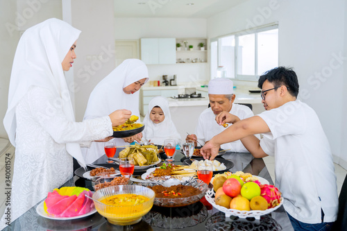 Happy muslim family eating traditional food together