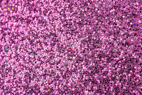 Bright picture of purple sparkles close-up. Festive background for sites and layouts.