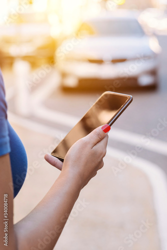 Murais de parede View of female arm and hand ordering a ride share in the city - Urban - Modern -