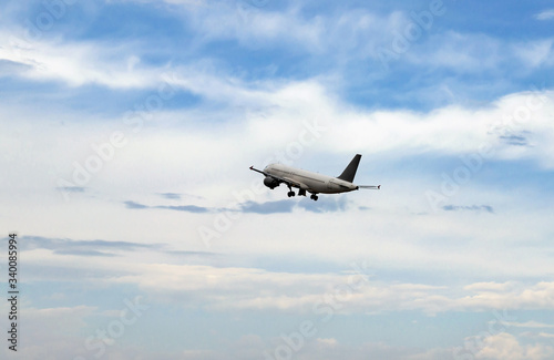 plane on take-off, in the sky among white clouds