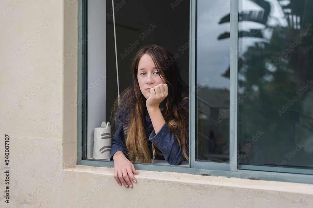 view of teenager through window view of teenager through window