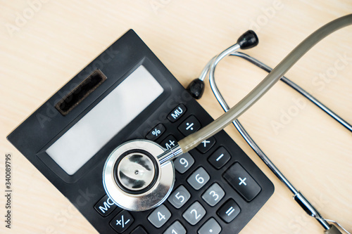 Top view of stethoscope and calculator