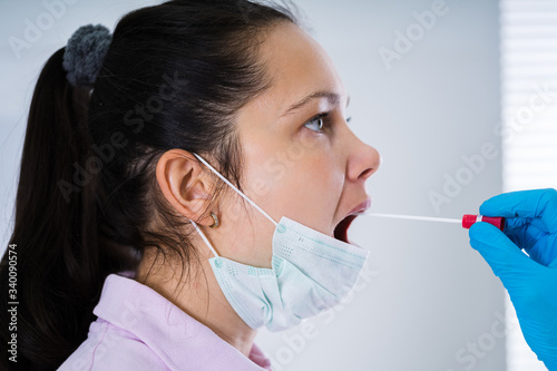 Doctor Taking Mouth Fluid Swab Sample