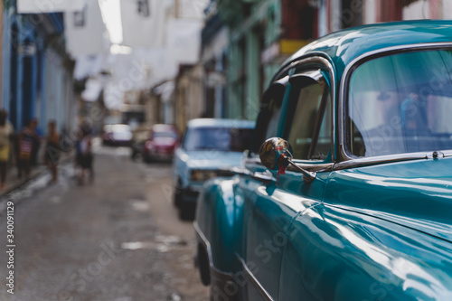 A green vintage car in Havana, Cuba